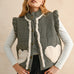 Model wearing the Rosie Gingham Sherpa Puffer Vest in black, front portrait view with sherpa heart pockets