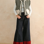 Full-body view of the black gingham sherpa puffer vest styled with dark pants and layered top
