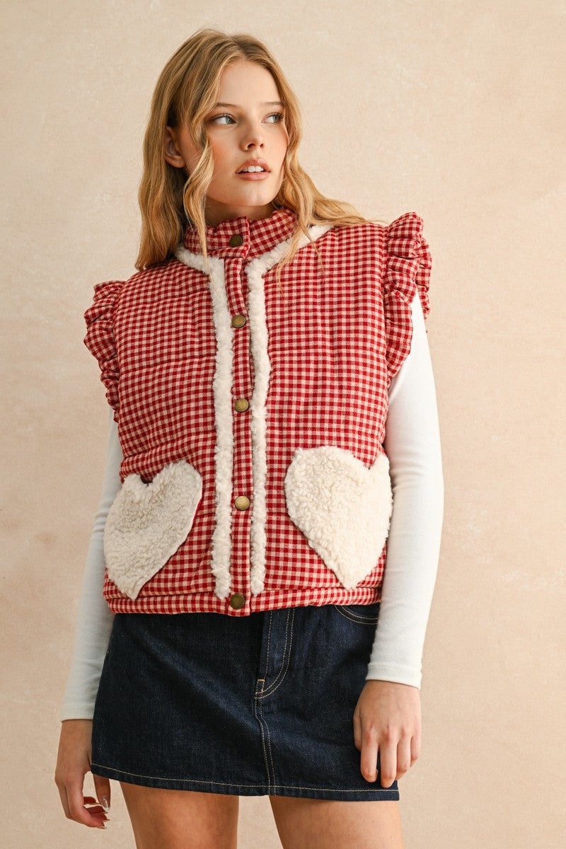 Front view of the Rosie Gingham Sherpa Puffer Vest in red showing stand collar and sherpa heart pockets