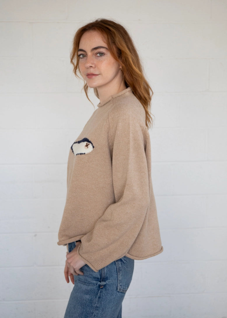 Side view of the oat balloon sleeve sweater showing sleeve volume and drape
