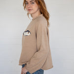 Side view of the oat balloon sleeve sweater showing sleeve volume and drape