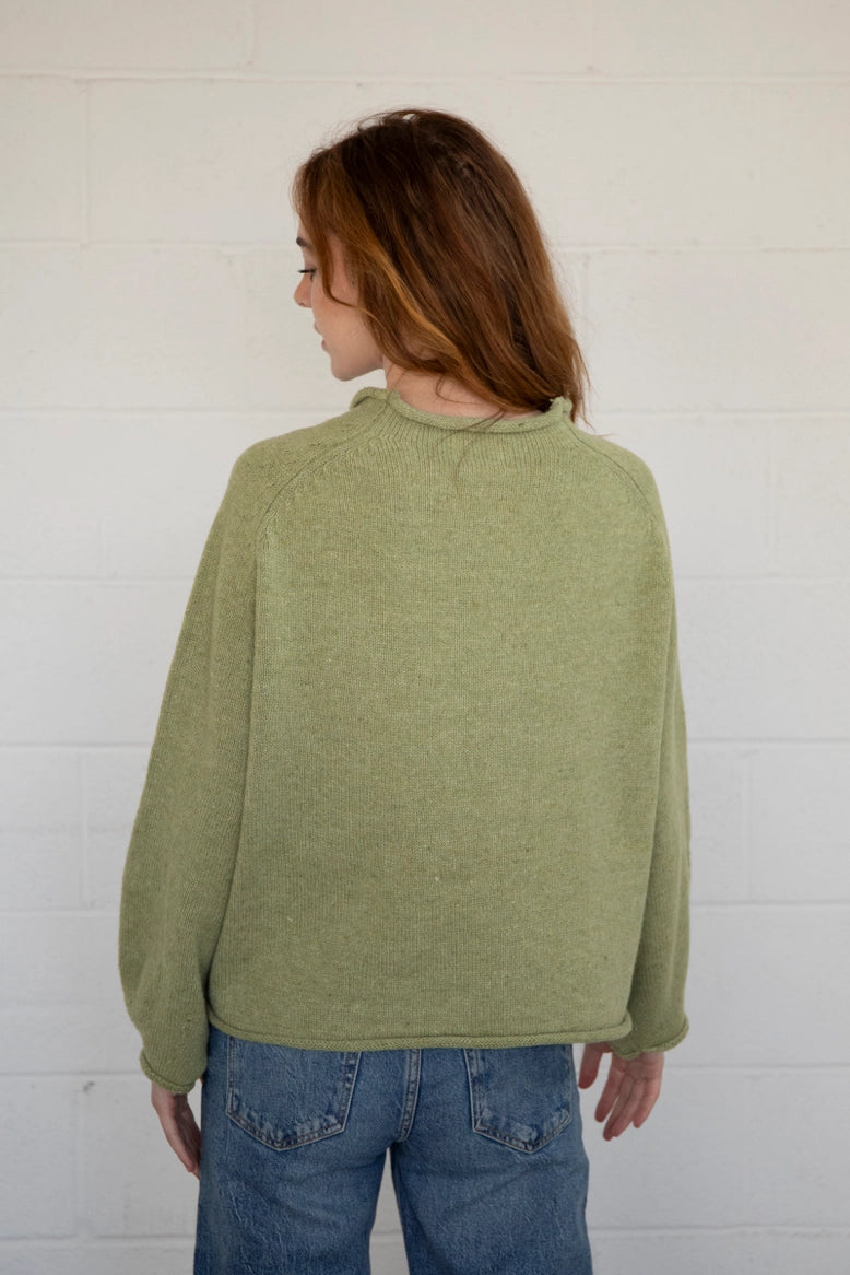 Back view of the olive balloon sleeve sweater showing relaxed silhouette