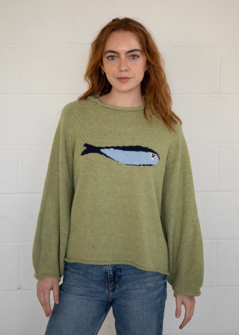Close-up front view of the olive balloon sleeve sweater highlighting knit texture and sardine graphic