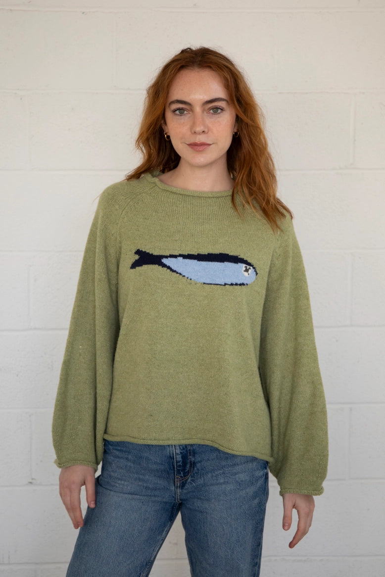 Close-up front view of the olive balloon sleeve sweater highlighting knit texture and sardine graphic