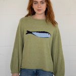 Close-up front view of the olive balloon sleeve sweater highlighting knit texture and sardine graphic