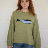 Close-up front view of the olive balloon sleeve sweater highlighting knit texture and sardine graphic