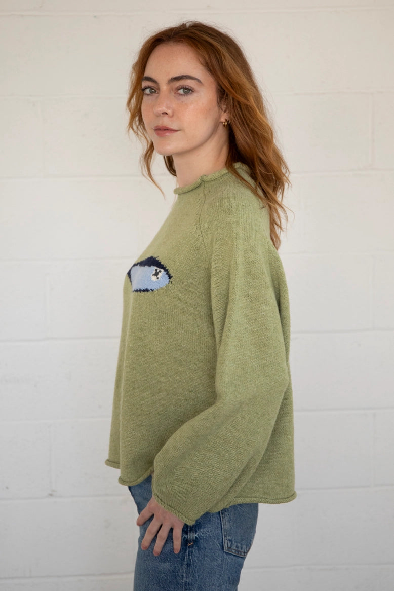 Side view of the Sardine Balloon Sleeve Sweater in olive showing sleeve volume and drape