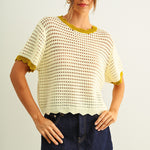 Scalloped mesh knit short sleeve top in cream with lemongrass trim styled with denim skirt
