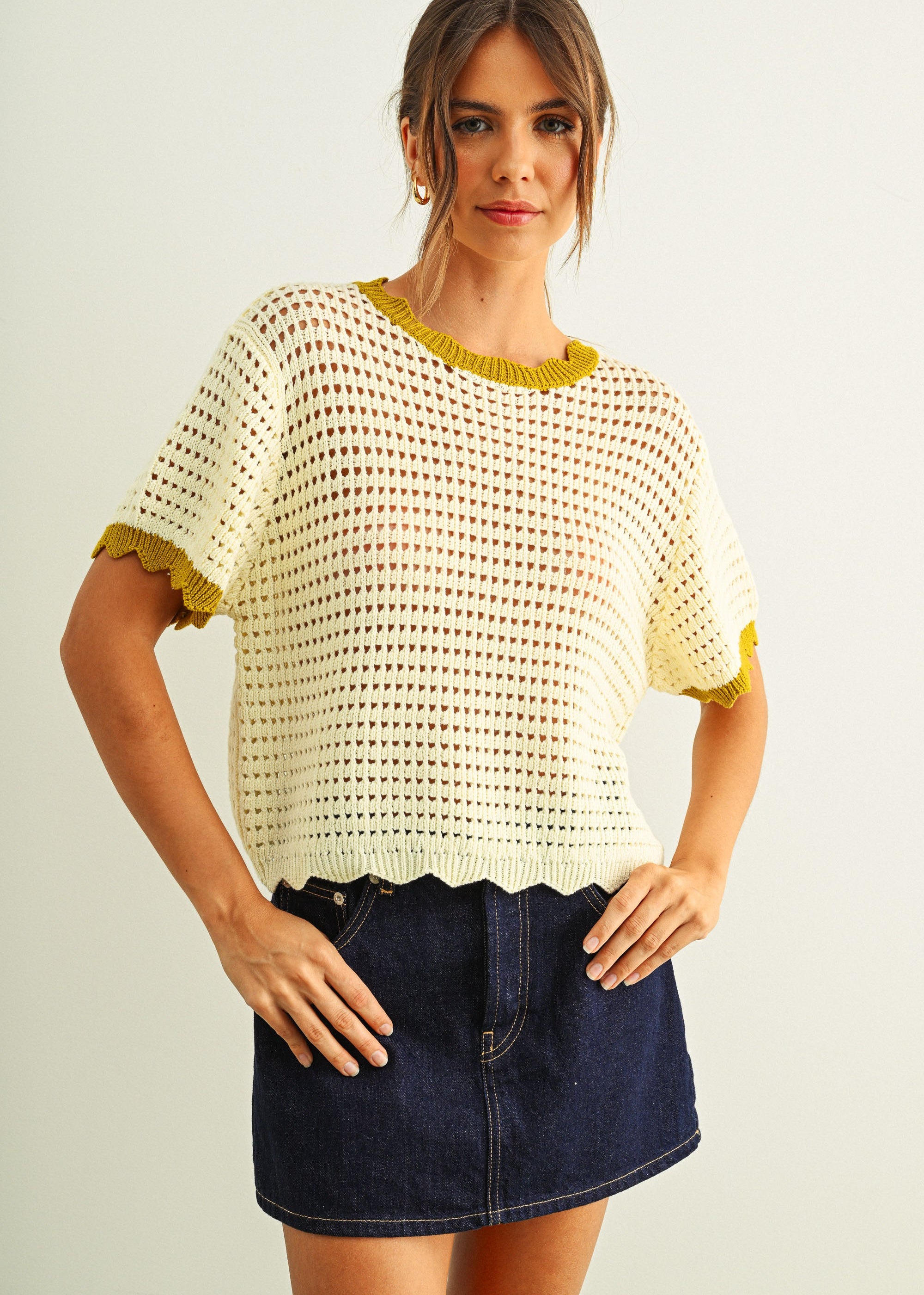 Scalloped mesh knit short sleeve top in cream with lemongrass trim styled with denim skirt