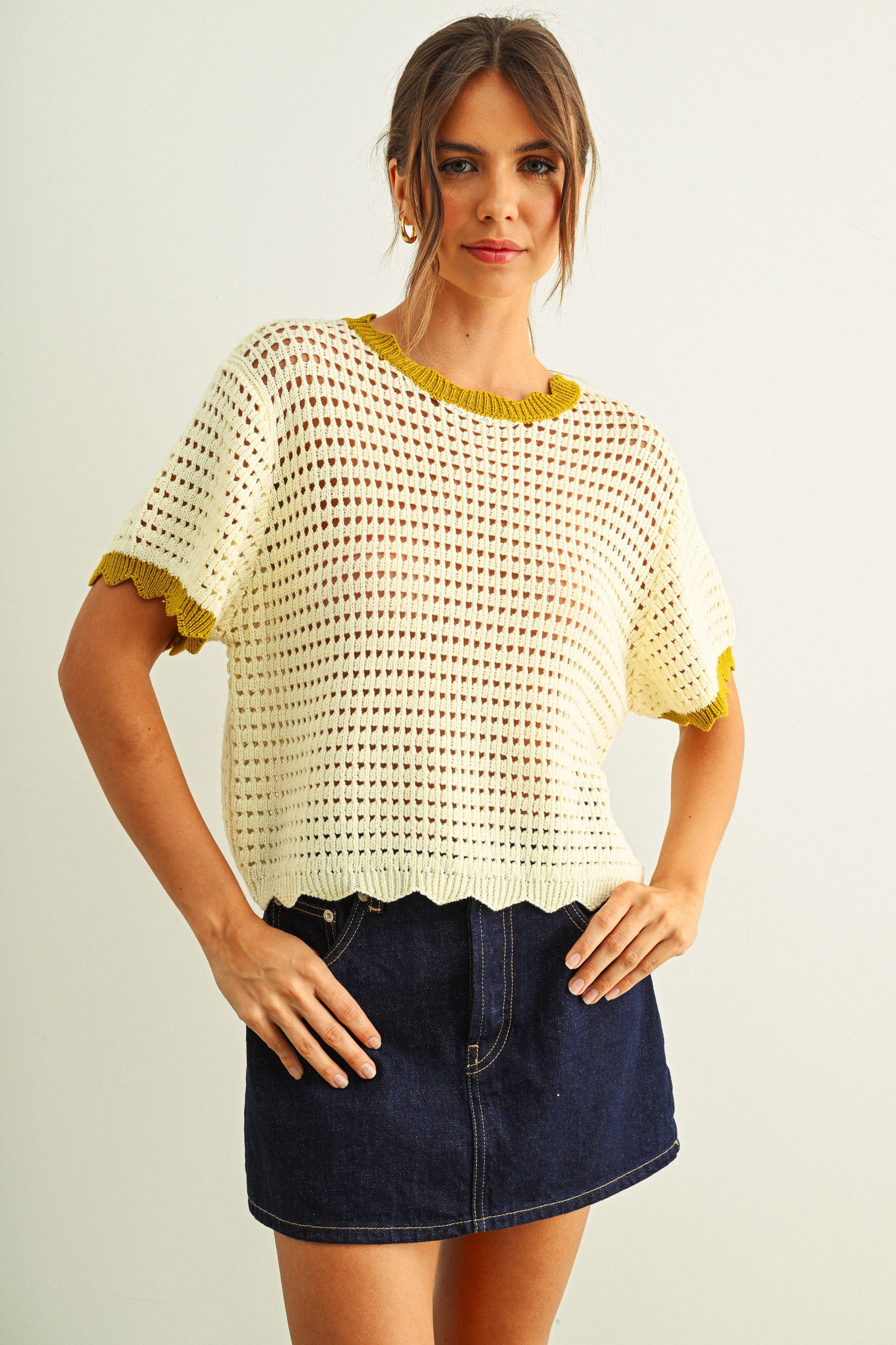 Scalloped mesh knit short sleeve top in cream with lemongrass trim styled with denim skirt