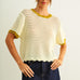 Scalloped mesh knit short sleeve top in cream with lemongrass trim styled with denim skirt