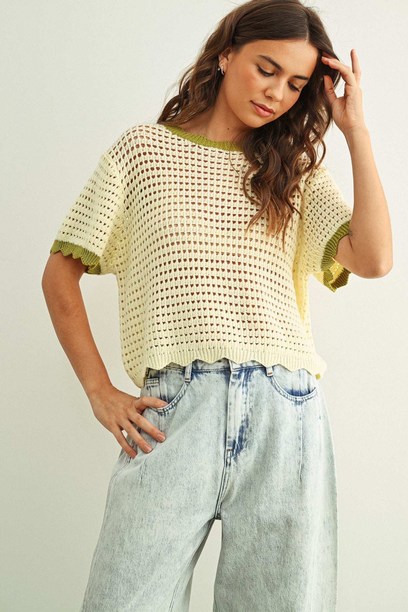 Scalloped mesh knit short sleeve top in cream with sage trim styled with casual outfit