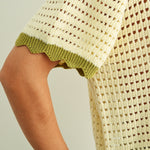 Close-up of breathable mesh knit pattern on cream cotton short sleeve top with sage trim