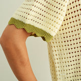 Close-up of breathable mesh knit pattern on cream cotton short sleeve top with sage trim