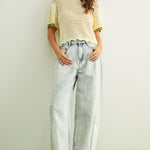 Woman wearing cream scalloped mesh knit short sleeve cotton top with sage trim