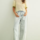 Woman wearing cream scalloped mesh knit short sleeve cotton top with sage trim