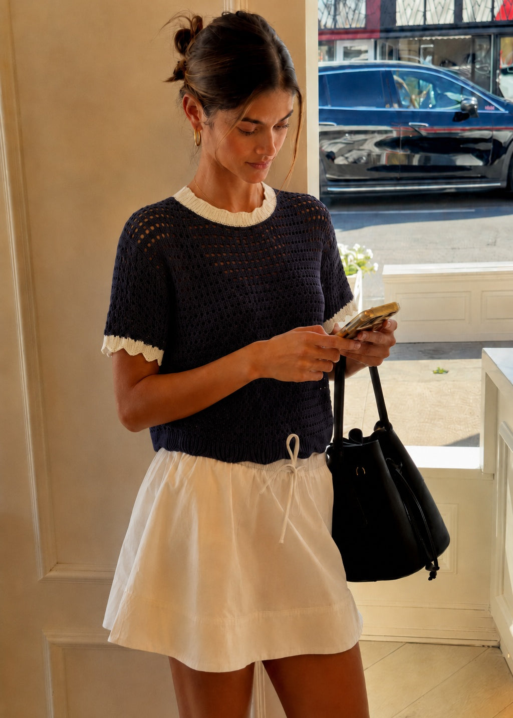 Navy and cream scalloped mesh knit short sleeve top styled for an easy everyday outfit.