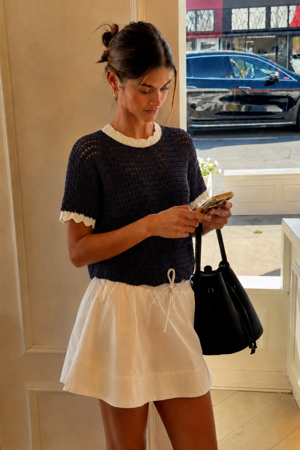 Navy and cream scalloped mesh knit short sleeve top styled for an easy everyday outfit.