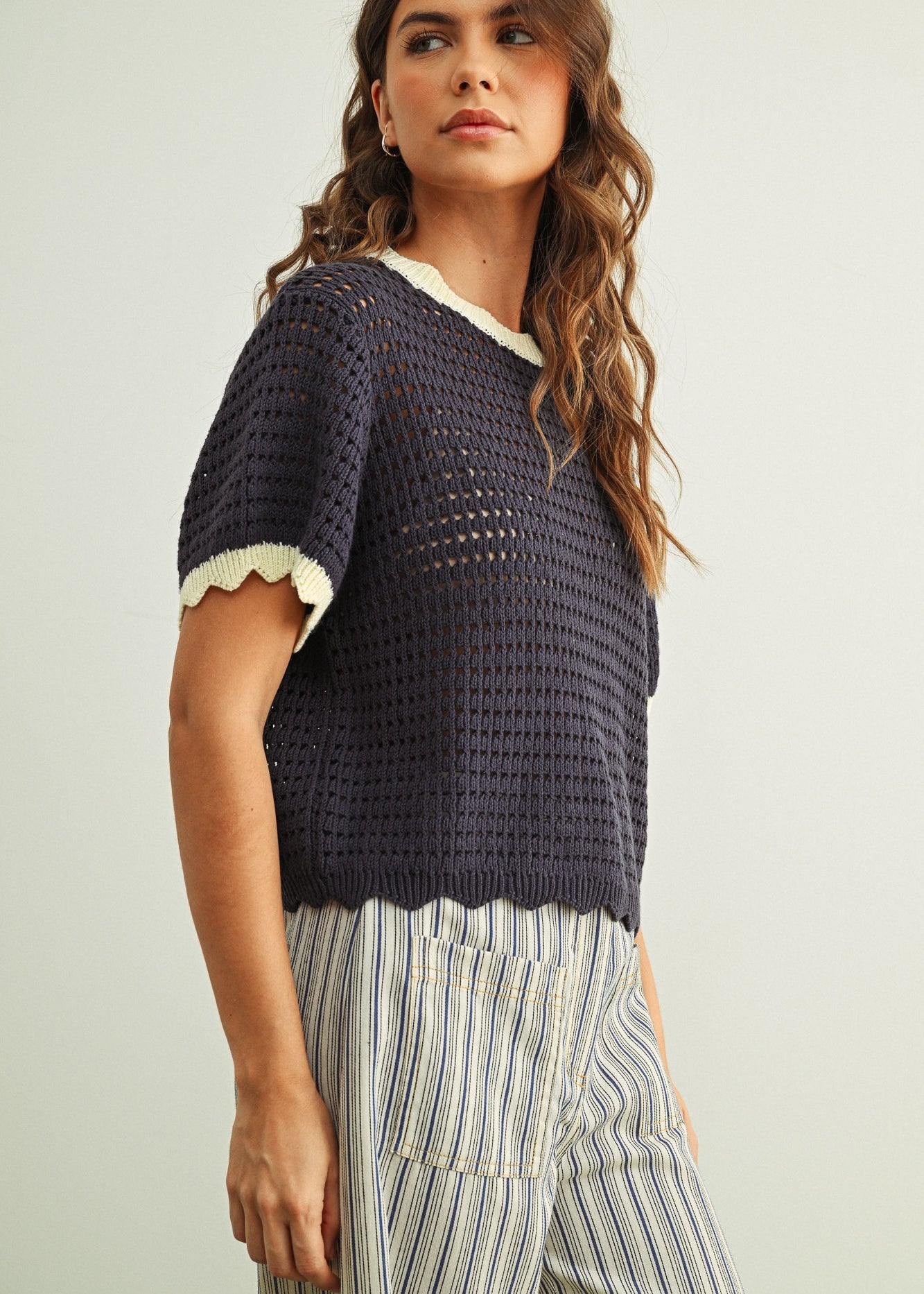 Side view of Scalloped Mesh Knit Short Sleeve Top in navy and cream with breathable cotton mesh knit and relaxed fit.