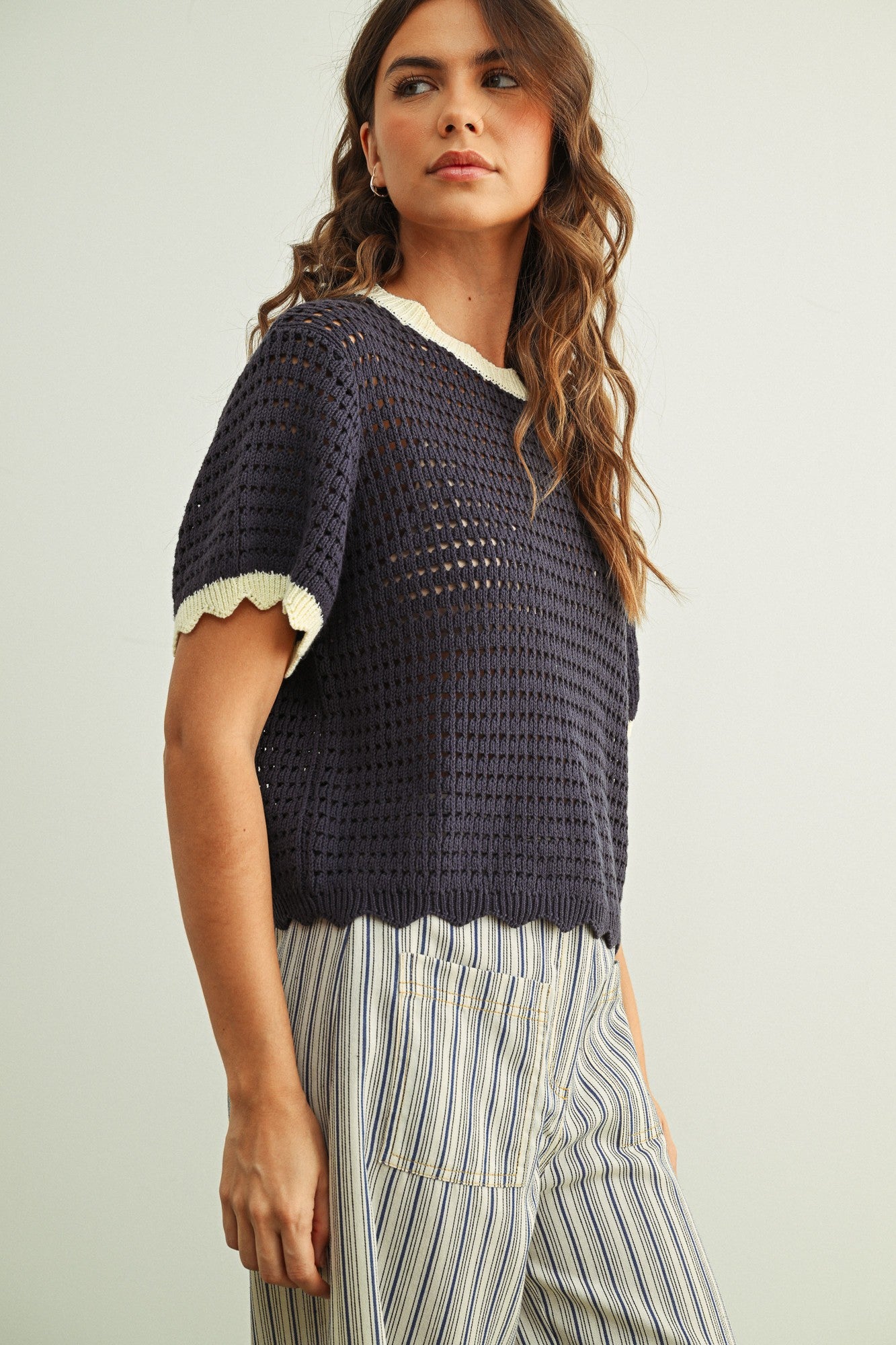 Side view of Scalloped Mesh Knit Short Sleeve Top in navy and cream with breathable cotton mesh knit and relaxed fit.