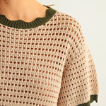 Close-up of breathable mesh knit texture on tan cotton short sleeve top with olive trim