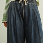 Close-up of Scout Lightweight Pull-On Wide Leg Jeans in denim with elastic waistband, drawstring waist, and front pleat detail