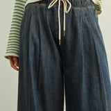 Close-up of Scout Lightweight Pull-On Wide Leg Jeans in denim with elastic waistband, drawstring waist, and front pleat detail