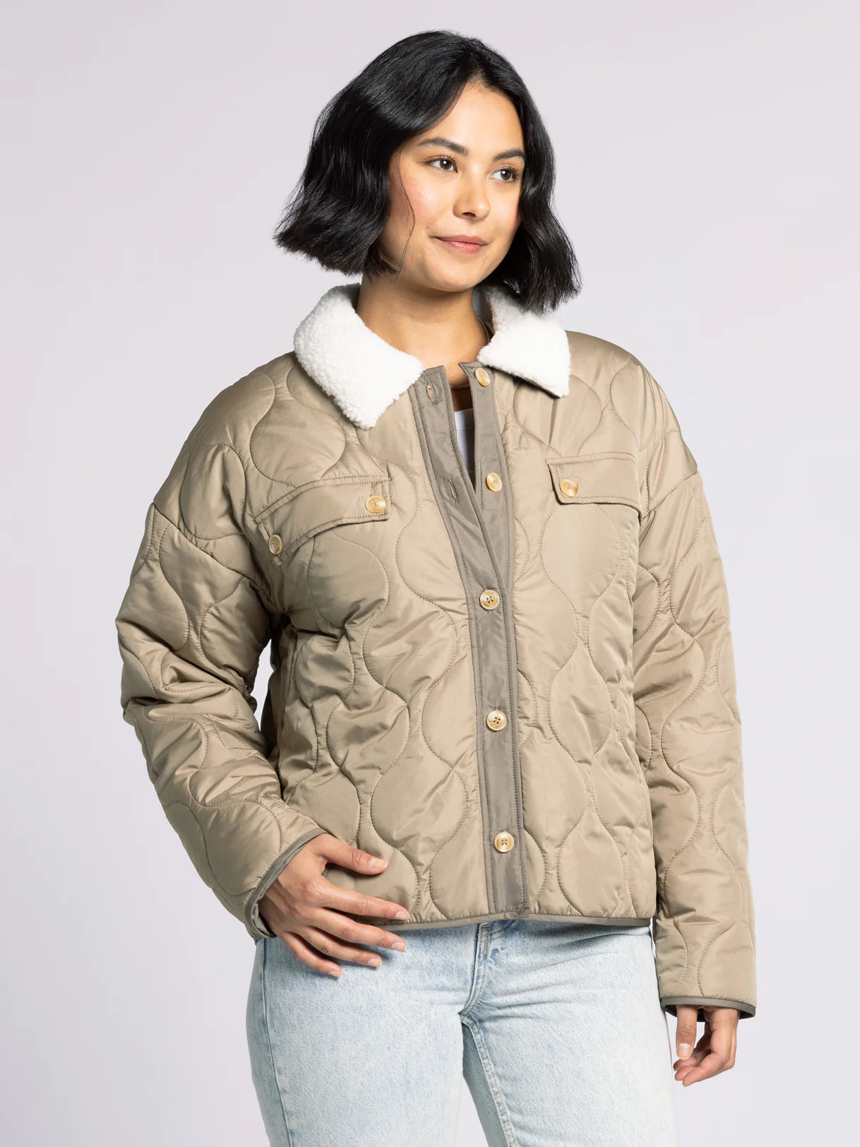 Woman wearing the Aura Sherpa Collar Quilted Puffer Coat in olive — soft quilted outerwear with cozy sherpa collar.