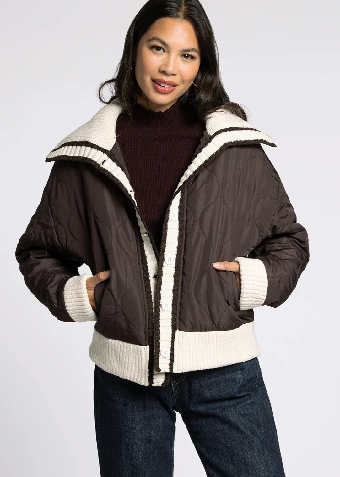 Front portrait view of model wearing the Sienna Knit Collar Puffer Jacket in brown with knit collar and trim