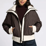 Front portrait view of model wearing the Sienna Knit Collar Puffer Jacket in brown with knit collar and trim
