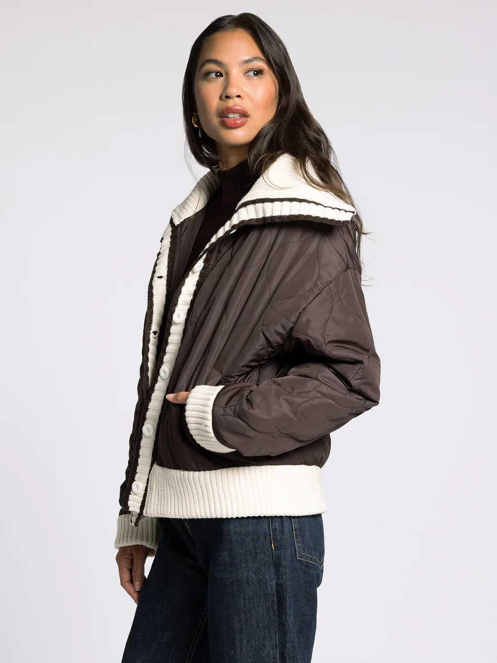 Side view of the brown quilted puffer jacket showing the collar shape and relaxed fit