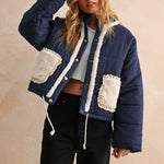 Front view of the Sienna Sherpa Pocket Quilted Jacket in blue with button-down front and drawstring hem
