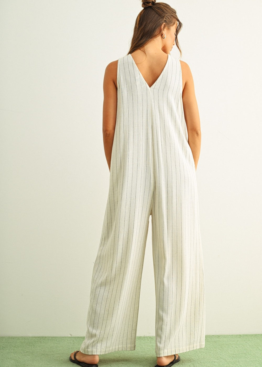 Back view of Sienna cream and black striped viscose linen jumpsuit with wide-leg silhouette