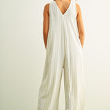 Back view of Sienna cream and black striped viscose linen jumpsuit with wide-leg silhouette