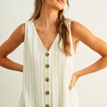 Close-up of button-front detail on Sienna cream and black striped jumpsuit