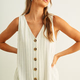 Close-up of button-front detail on Sienna cream and black striped jumpsuit