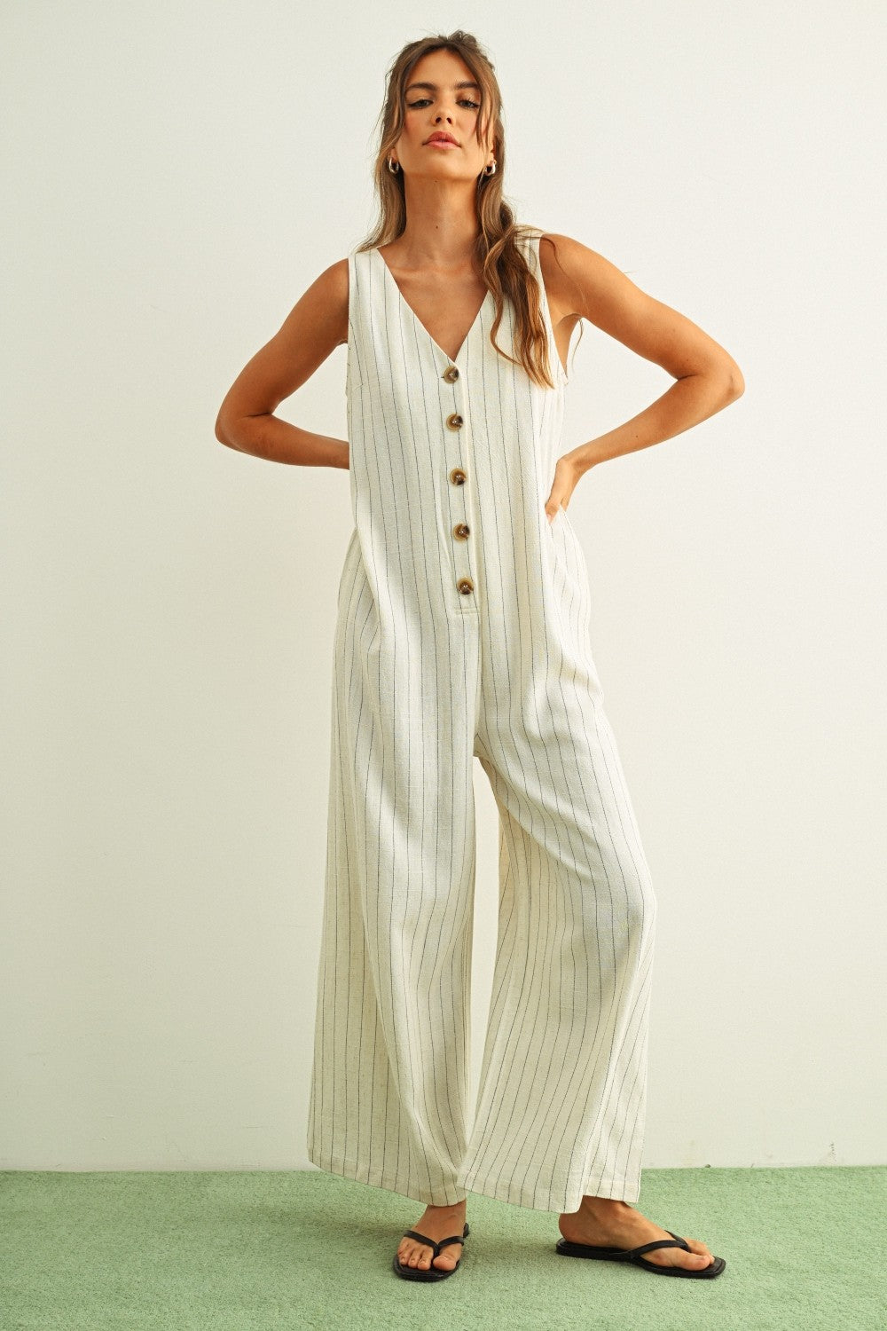 Sienna striped button-front jumpsuit in cream and black with wide-leg silhouette and side pockets