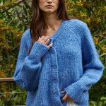 Model wearing the Skyline Crew Neck Button Cardigan in cobalt blue, front view, relaxed fit
