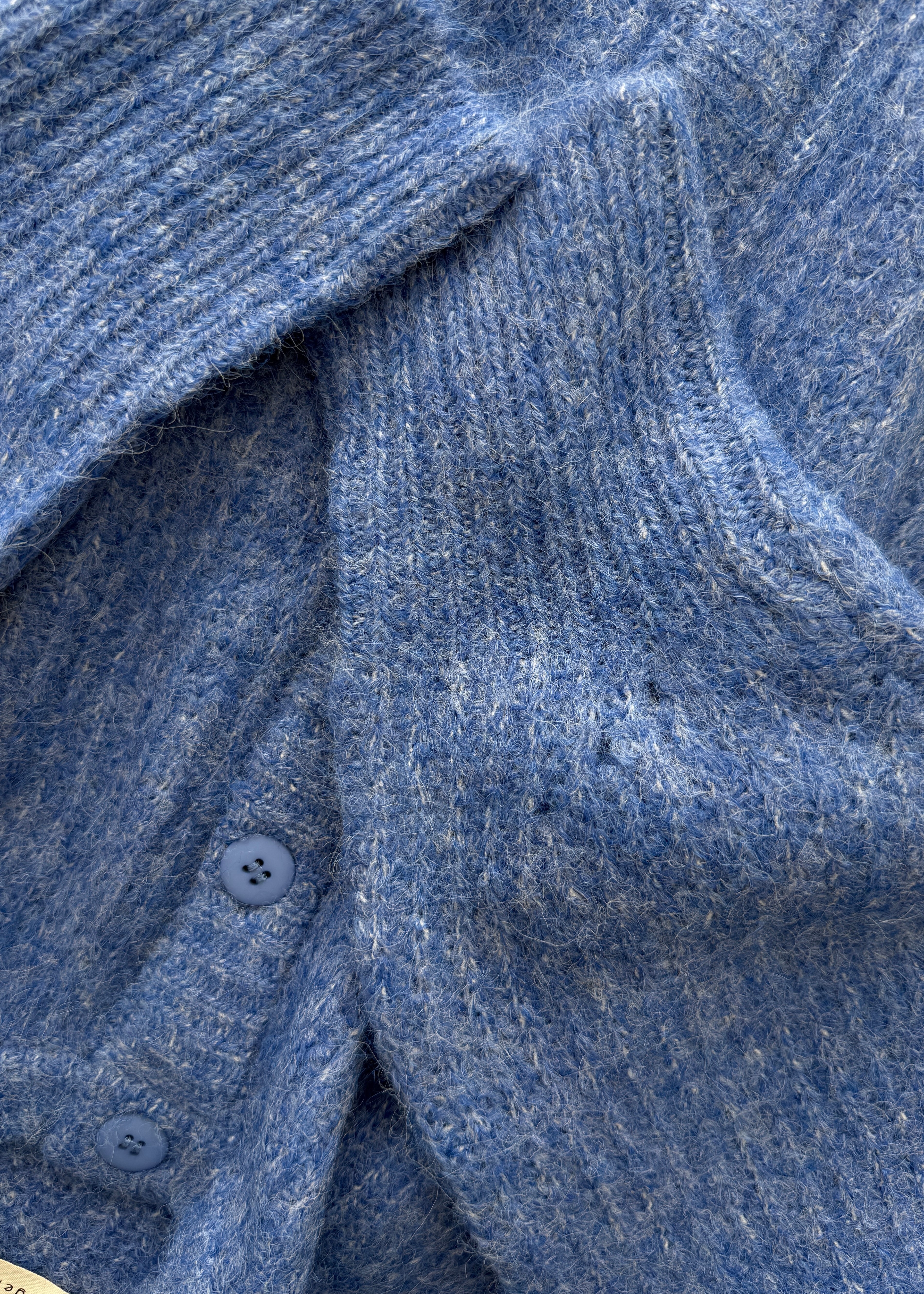 Close-up of the cobalt blue textured knit fabric on the Skyline button cardigan
