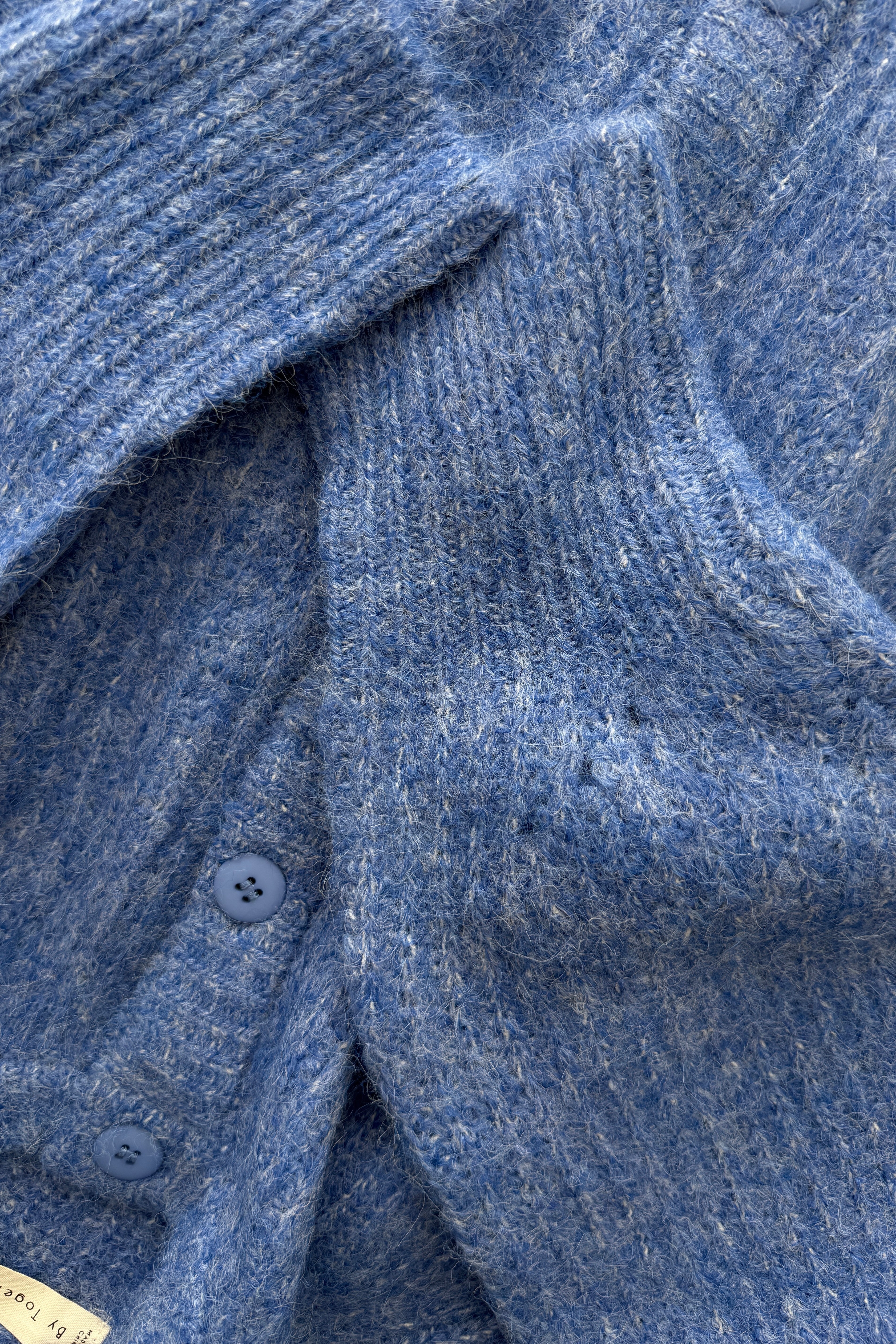 Close-up of the cobalt blue textured knit fabric on the Skyline button cardigan