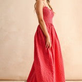 Side view of cherry gingham cotton maxi dress with smocked bodice