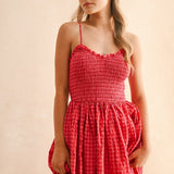 Close-up of smocked bodice on cherry gingham cotton maxi dress