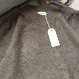 Close-up of lightweight knit texture on soft balloon sleeve sweater in dark mocha