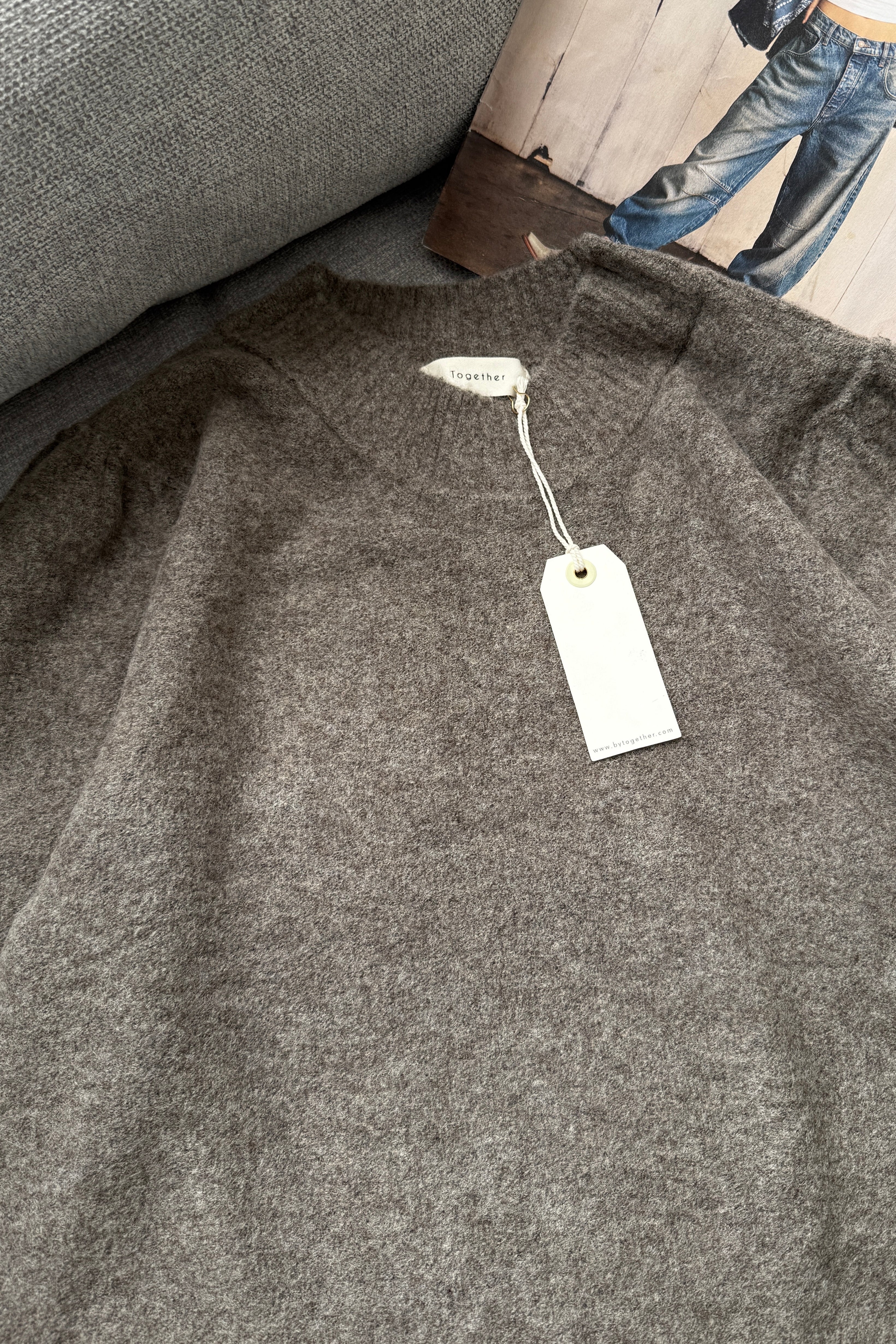 Close-up of lightweight knit texture on soft balloon sleeve sweater in dark mocha