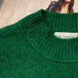 Close-up of lightweight knit texture on soft balloon sleeve sweater in kelly green