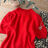 flat lay of the red balloon sleeve short sleeve sweater highlighting the crew neckline and hem