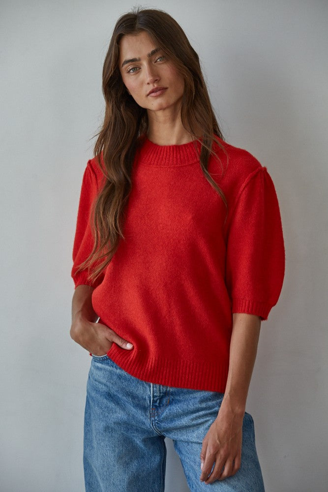 Model wearing the Soft Balloon Sleeve Short Sleeve Sweater in red, front portrait view