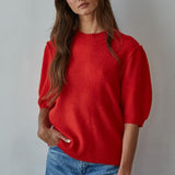 Model wearing the Soft Balloon Sleeve Short Sleeve Sweater in red, front portrait view