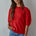 Model wearing the Soft Balloon Sleeve Short Sleeve Sweater in red, front portrait view