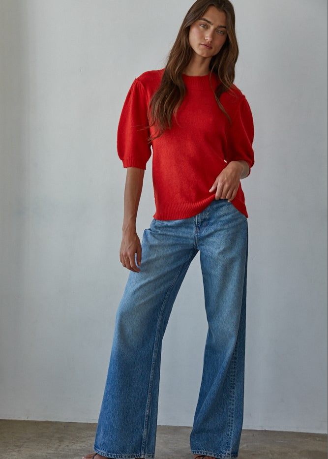 Full-body front view of the red short sleeve balloon sleeve sweater styled with blue jeans